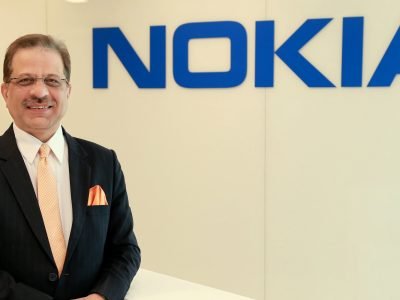 Nokia Senior Vice President and Head of India Market Sanjay Malik with NOKIA logo in the background.