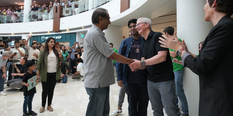 Tim Cook shakes hands with a customer at inauguration of Apple Saket