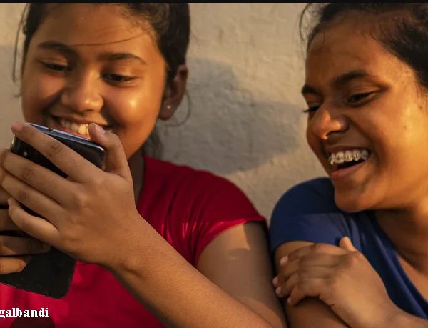 Jugalbandi - Young girls peeping into mobile phone