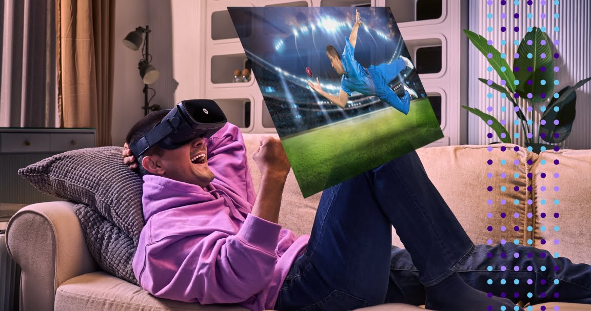 A man wearing JioDive VR Headsets enjoys a cricket match on his couch